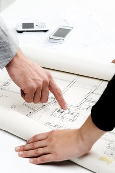 Architect�s hands pointing on the blueprint of new house project 