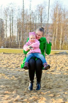 Mother and daughter on a swing