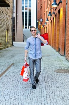 Portrait of handsome male with shopping bags