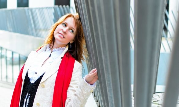 Portrait of pretty girl next to a steel fence