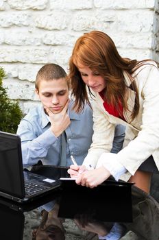 Business partners meeting: Male and female with laptop