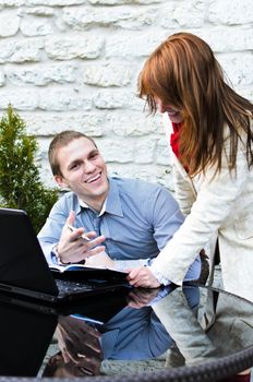 Business partners meeting: Man and woman is something fun to discuss
