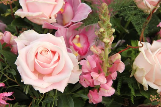 Soft pink rose and orchid in a bridal bouquet