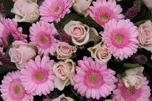 Pink roses and gerberas in a bridal floral arrangement