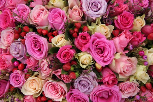 Various shades of pink roses in a wedding centerpiece