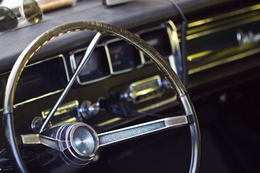 Closeup on old classic car steering wheel, interior retro oldtimer