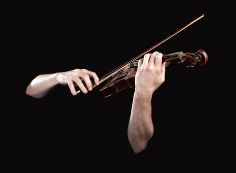Hands playing  wooden violin on black background