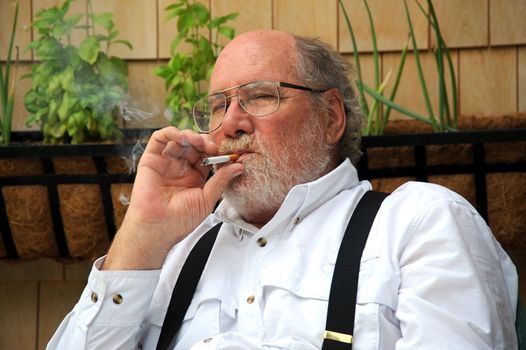 Country gentleman relaxing at home with a smoke.