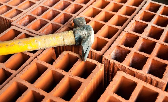 Hollow brick with an hammer on construction site