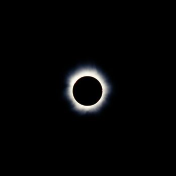 Total solar eclipse with the moon obscuring the disc of the sun so that only the corona is visible as a bright ring