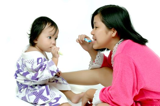 A mother taught her how to brush teeth to his daughter