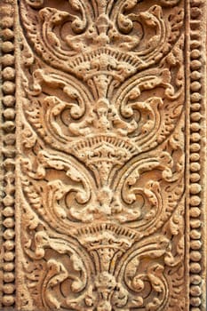 Old stone carvings on the wall temple in Thailand