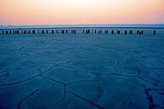 Dried-up salt lake at sunset at Kuyalnik lake