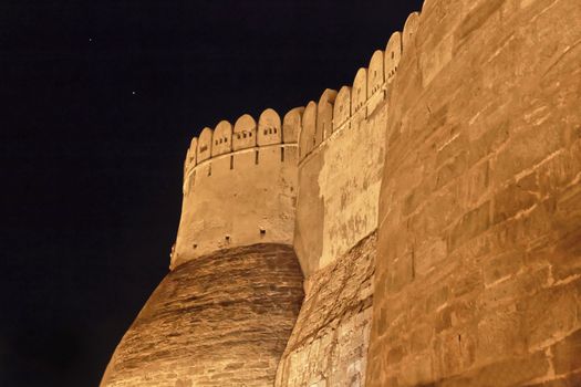 Landscape of the exterior near the main gate and bastions of Kumbhalghar Fort at night