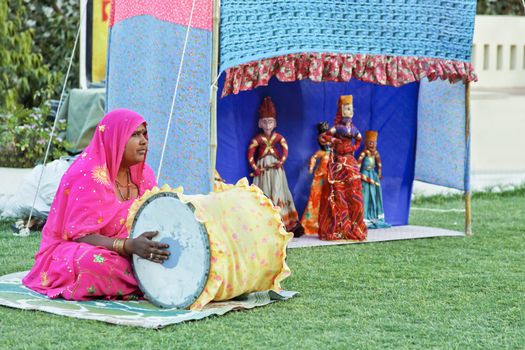 Man and woman team of puppeteers performing folklore stories of historical characters generally involving the exploits of local heroes and maharajahs