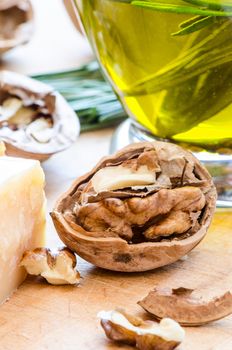 Nut parmesan and olive oil on wooden cutting board