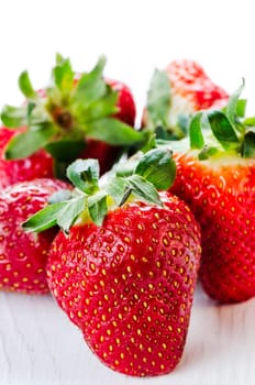 Group of strawberries on white wooden table