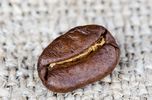 Coffee beans on a rough cloth close up