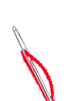 Macro needle and red thread