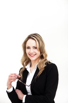 Successful female executive or businesswoman in a stylish jacket smiling happily with her glasses in her hand isolated on white