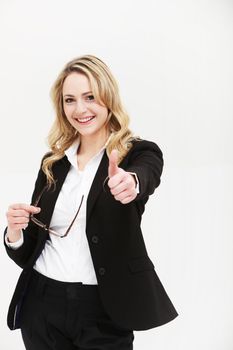 Positive motivated businesswoman giving thumbs up with an enthusiastic smile