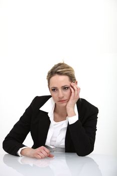 Studio shot of depressed business woman on white background with copy space