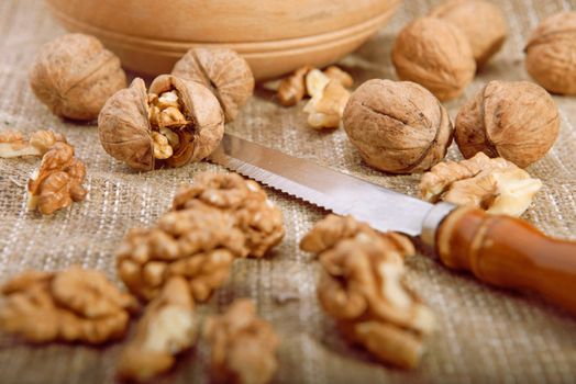 Walnuts on tablecloth with knife