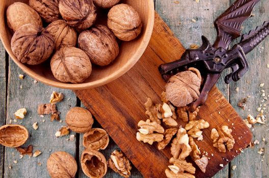 Nutcracker with walnuts on wooden table