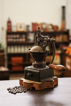 Still life with coffee beans and old grinder