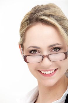 Closeup cropped view of the face of a smiling woman peering over the top of her glasses