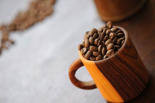 wooden cup with coffee beans