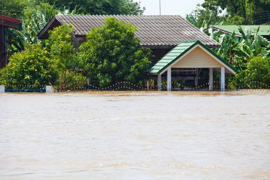 flood waters overtake a house in Thailand
