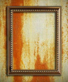 Gold frame on rust metal background
