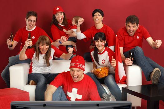 Photo of Swiss sports fans watching television and cheering for their team. Hopp Schwiiz!