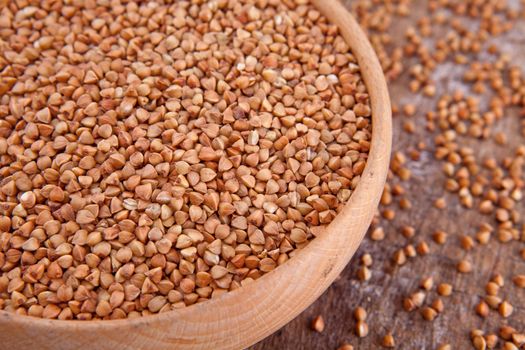 Crude buckwheat in te wooden plate