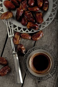 Dried fruits with a coffee on a wooden table