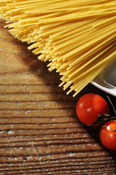 uncooked spaghetti noodles . Italian pasta with tomatoes