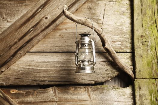 oil lamp hanging against wooden background