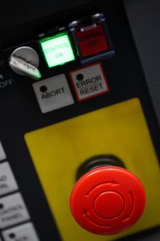 Red stop button in an  machine control panel 
