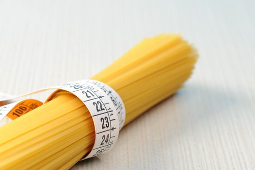 diet concept, Spaghetti with measuring tape 