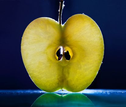 Slice of apple on black background