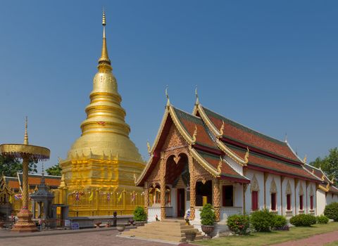 The 46-metre tall golden Chedi which is a major place of worship, Phra That Hariphunchai Woramahawihan Temple, Lamphun, Thailand