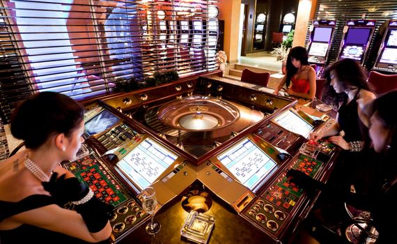 some blured women playing on electronic roulette table in casino