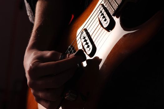  rock guitarist on black background