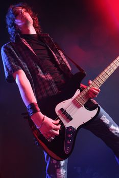 a bassist plays at a live concert