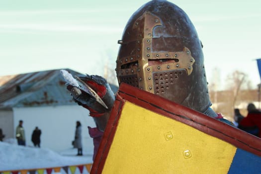 warlike knight in armor against the fortress wall