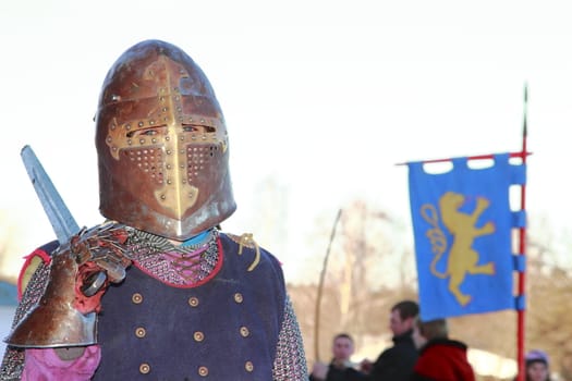 warlike knight in armor against the fortress wall