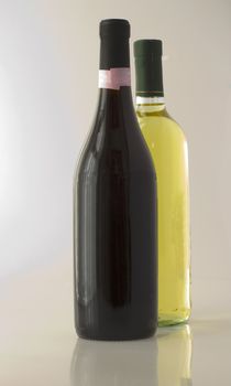 Wine bottle of red and white wine with reflection