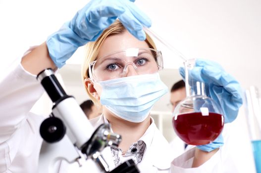 chemist working in the laboratory, mix liquid