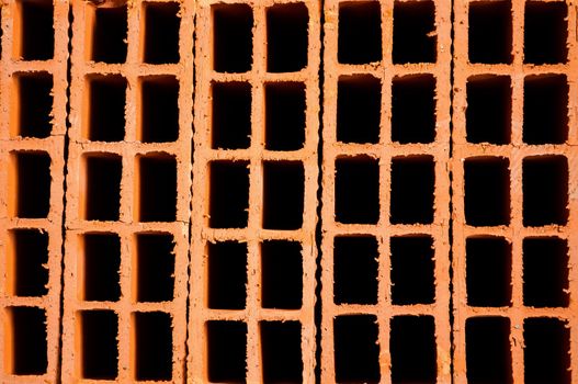 Orange hollow clay brick background for construction